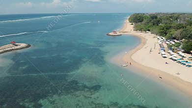 Aerial Footage of the beautiful Sanur Beach and the City in the background in Bali Indonesia
