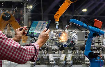 Engineer touch screen control robot the production of factory parts engine manufacturing industry