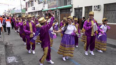 Latacunga, Ecuador - 20180925 - Couples in Purple Dance in Mama Negra Parade.