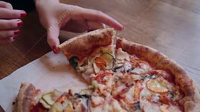 Close-up Of People Hands Taking Slices Pizza. Frame. Takes eating a slice of pizza with cheese, tomatoes and ham