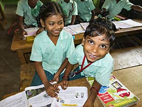 Portrait of children friends classmates studying with books indoors at the school. School kids enjoying friendship, happy for ngo