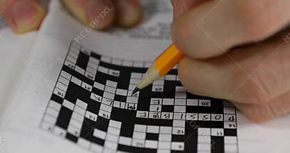 Brain training - hand doing crossword puzzle