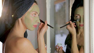 Aromatic botanical cosmetics. Dried herbs flowers mixture, facial mud clay mask, oils, applying brush. Holistic herbal skincare