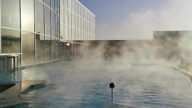 Thermal pool outdoor - a lot of steam over watersurface