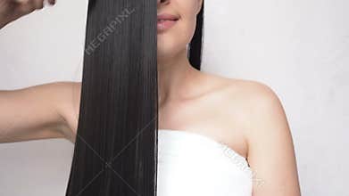 Young Girl Combing Long Smooth Hair After Making a Shower