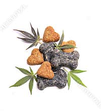 Dog treats and cannabis leaves isolated over white background