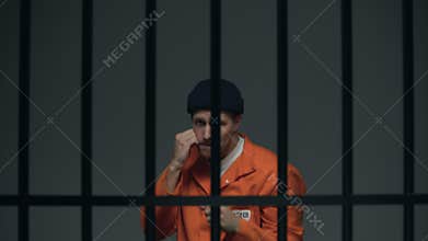 Caucasian male prisoner shadow boxing in cell, leisure time in prison, hobby