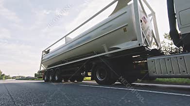 Cargo truck with fuel diesel cargo trailer driving on a highway