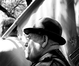 Man at May Day march wearing a hat