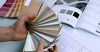 Interior designer choosing furniture material from sample palette