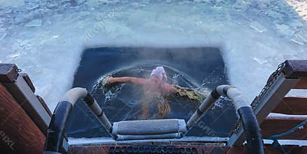 Person surfacing in an ice-hole after a swim