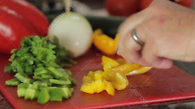 Panning motion and close up of someone cutting vegetables