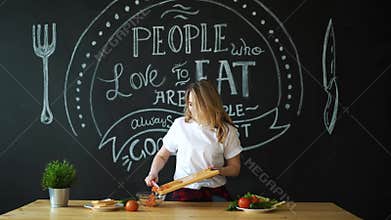 Young Woman Cooking in the kitchen. Healthy Food - Vegetable Salad. Diet. Dieting Concept. Healthy Lifestyle. Cooking At