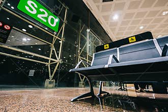 Empty Priority seats, chairs in the airport hall near departure gate at international airport reserved for disability
