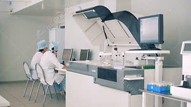 Modern Laboratory interior. Scientists works with lab equipment, computers.