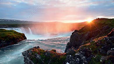 Fantastic sunset. Hodafoss very beautiful Icelandic waterfall 12 meters high. It is located in the north near Lake
