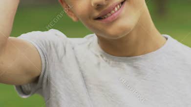 Handsome teenage boy smiling, posing for camera, clean skin in adolescence