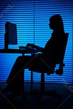 Silhouette of woman working computer (blind)