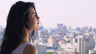 Woman feels serenity and calmness in city on background, mind peace urban scape
