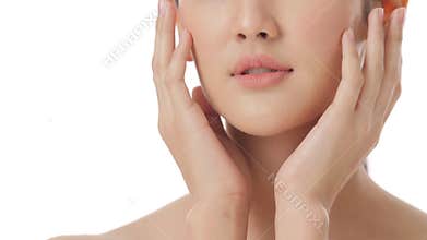 Close up portrait of beautiful young asian woman touching face and healthy skin in slow motion skincare concept.