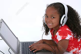 Adorable Six Year Old Girl Sitting On Floor With Laptop Computer