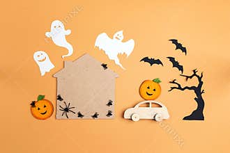 Flat lay Halloween background with cartoon house, car, pumpkins