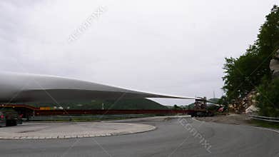 Lorry truck carry white wind turbine blade to generate clean energy