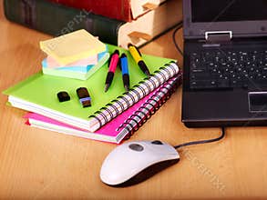 Books and laptop. School supplies.