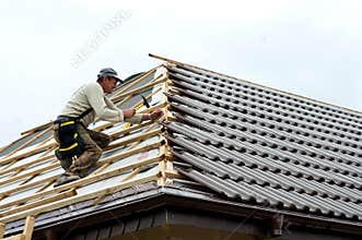 Roofer laying tiles