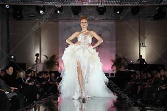 Woman wear wedding dress walks catwalk