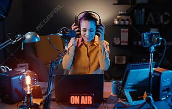 Young radio host broadcasting in the studio