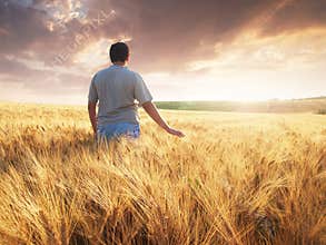 Boy walking through a field or meadow
