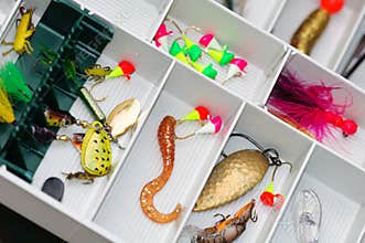 A fisherman tackle box with lures and gear.