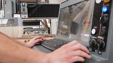Technician hands operating the control panel of high precision CNC machine