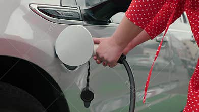 Female hands plugging in cable