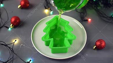 Pouring green jelly mix into the silicone mold