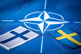 Flags of Sweden and Finland against the background of the NATO symbol, The concept of the Scandinavian countries joining the North