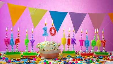 Birthday card with number 10 year. Happy birthday to a ten year old child on a beautiful pink background. Candles