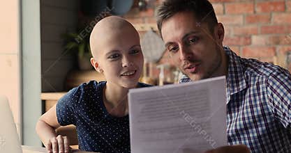 Bald woman her husband reading health test results celebrate remission