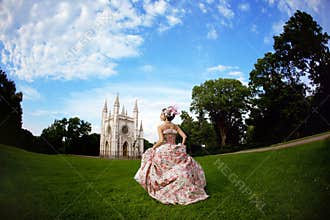 Princess in an vintage dress before castle