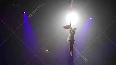 Aerial acrobat on the stage of the circus.