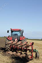 Tractor and plow at harvest
