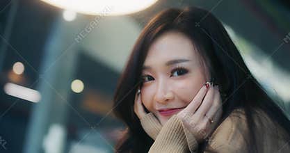 Beautiful young Asian woman smile happily, wave and look at camera. Handheld slow motion