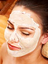 Woman having clay facial mask.