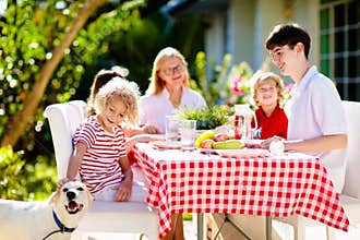 Family eating outdoor. Garden summer fun