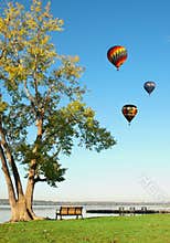 Hot air balloons over lake