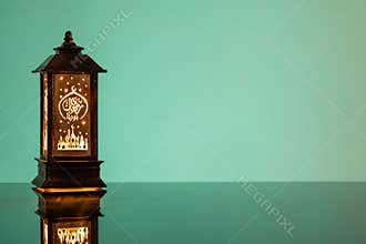 Eid Mubarak concepts with lamp inscribed with arabic text translated to english as Ramadhan is our light.