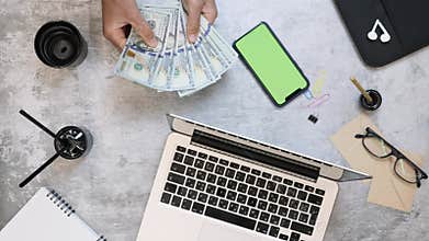 Making money online. Man counting cash money at office work desk. Businessman counts US dollar bills at workplace earning with int