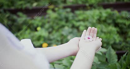 Close-up view of child holding delicate flower in hands