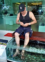 PHUKET, THAILAND: Man Getting Fish Foot Massage